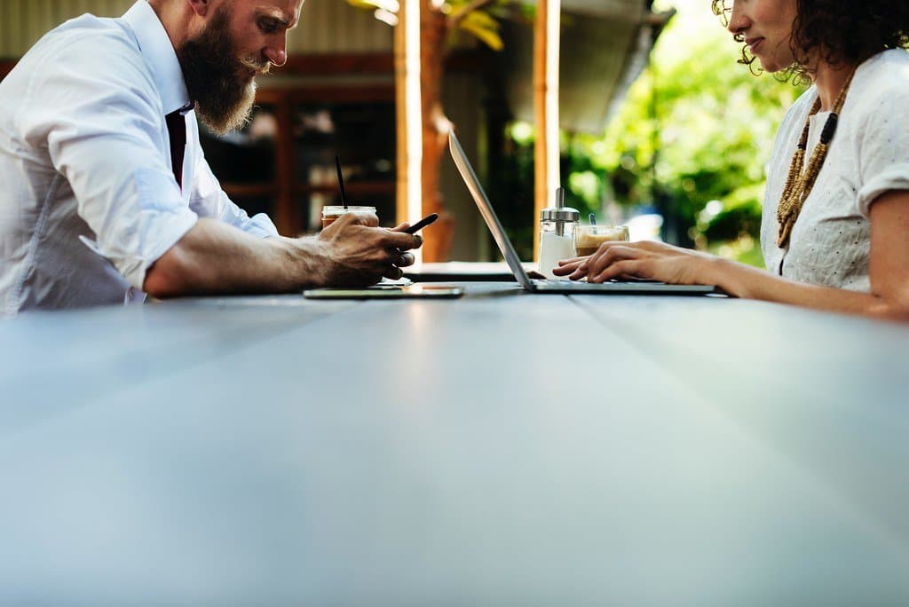 Two professionals reviewing a laptop screen together during a consulting meeting
